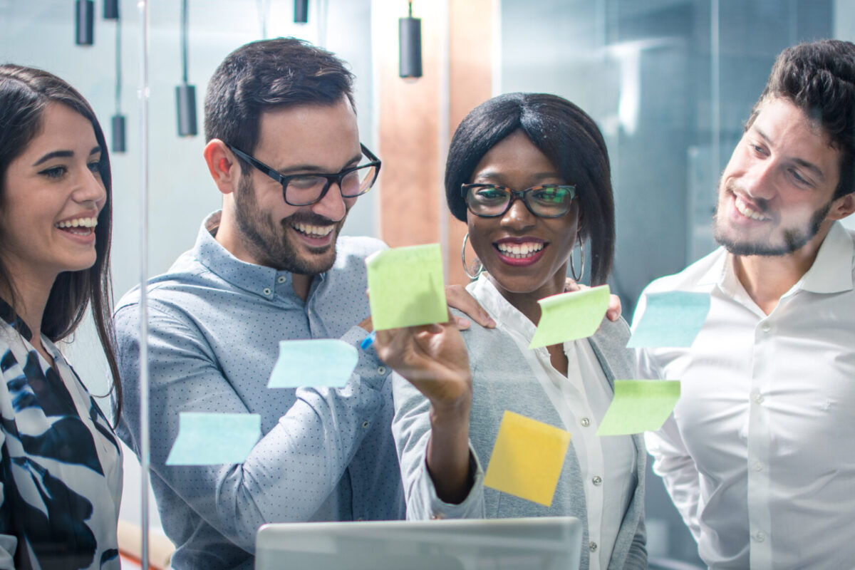Panoramic View Creative Group Of Business People Working With Sticky Notes On Glass Wall In Office Panoramic View Creative Group Of Business People Working With Sticky Notes On Glass Wall In Office